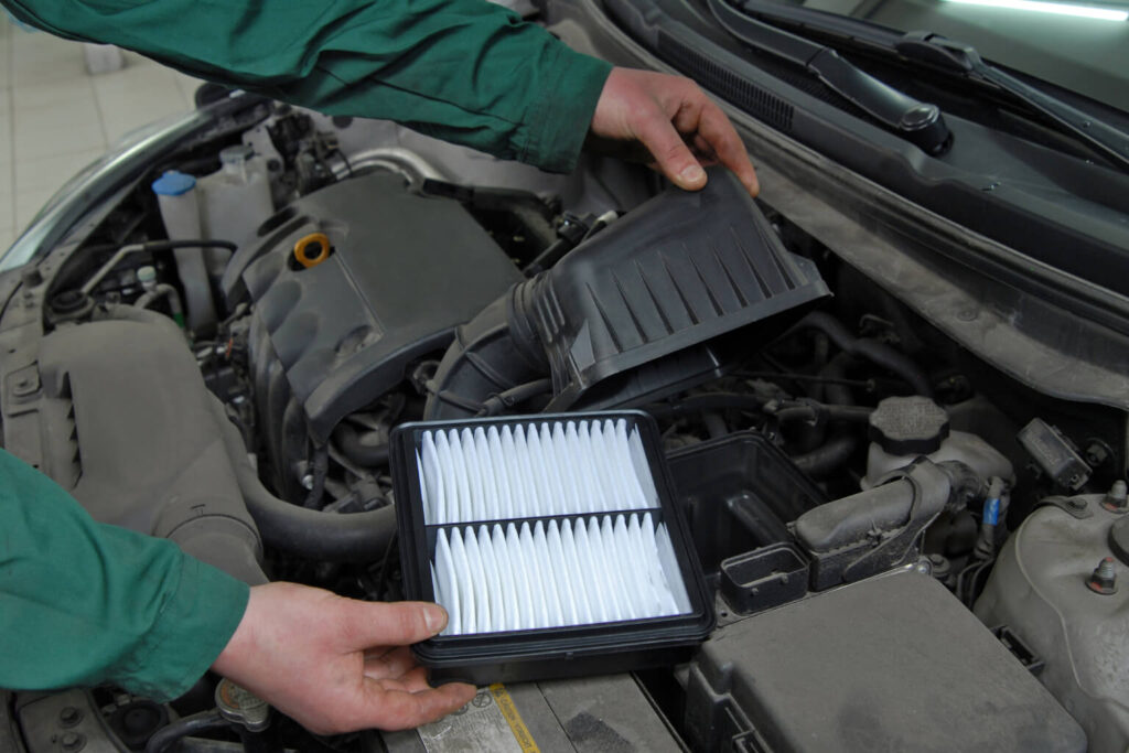 Mechanic holding car engine air filter
